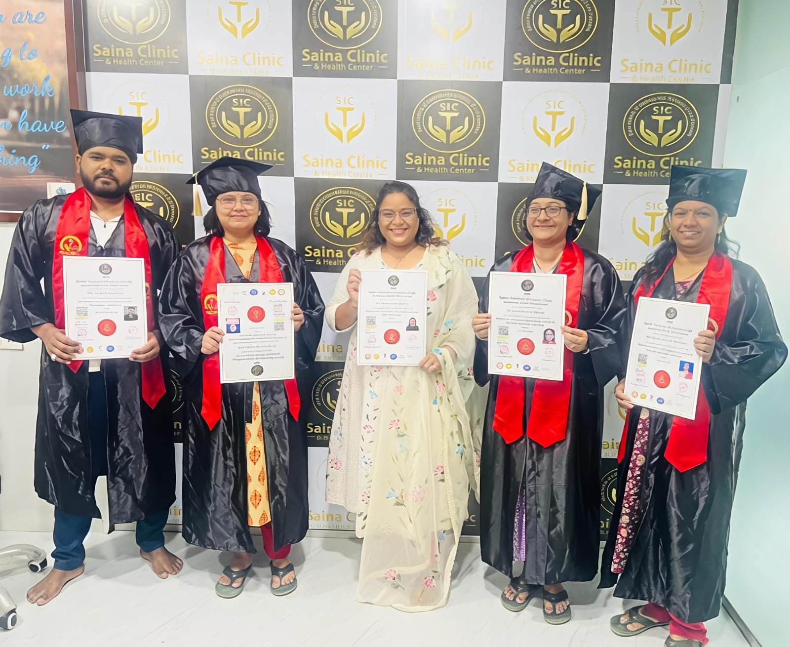 SIC graduates holding their certificates